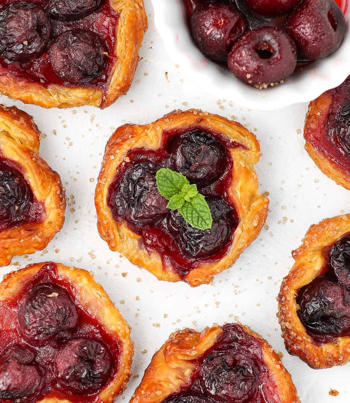 Baked tartlets seen from above on a white surface.
