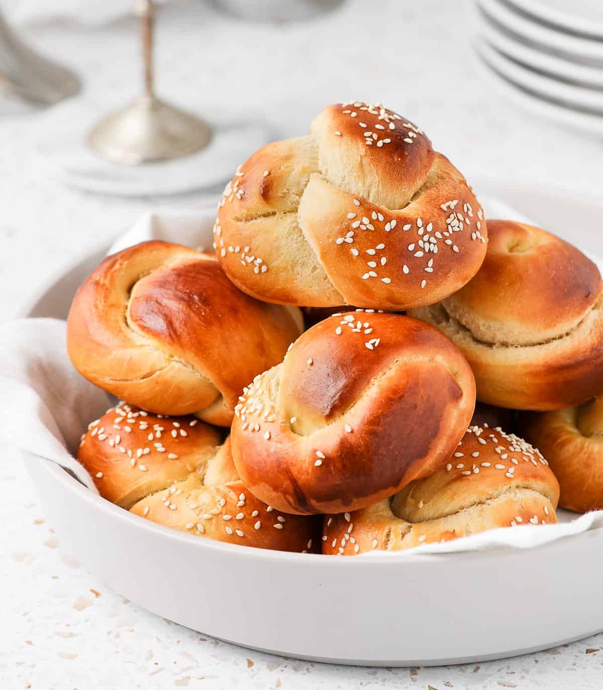 Rolls stacked in a large light grey bowl.