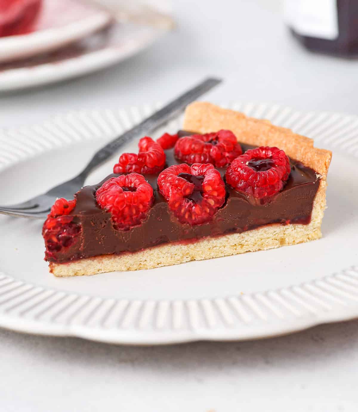 One slice of tart on a small white plate.