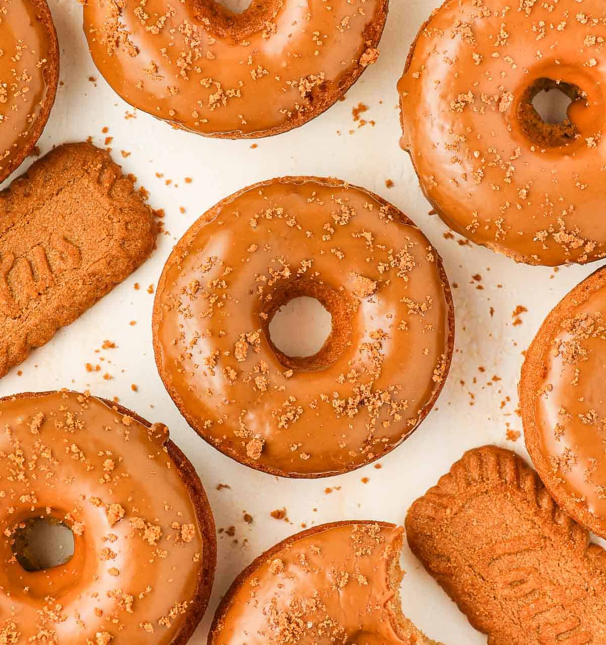 Donuts seen from above on an orange surface.