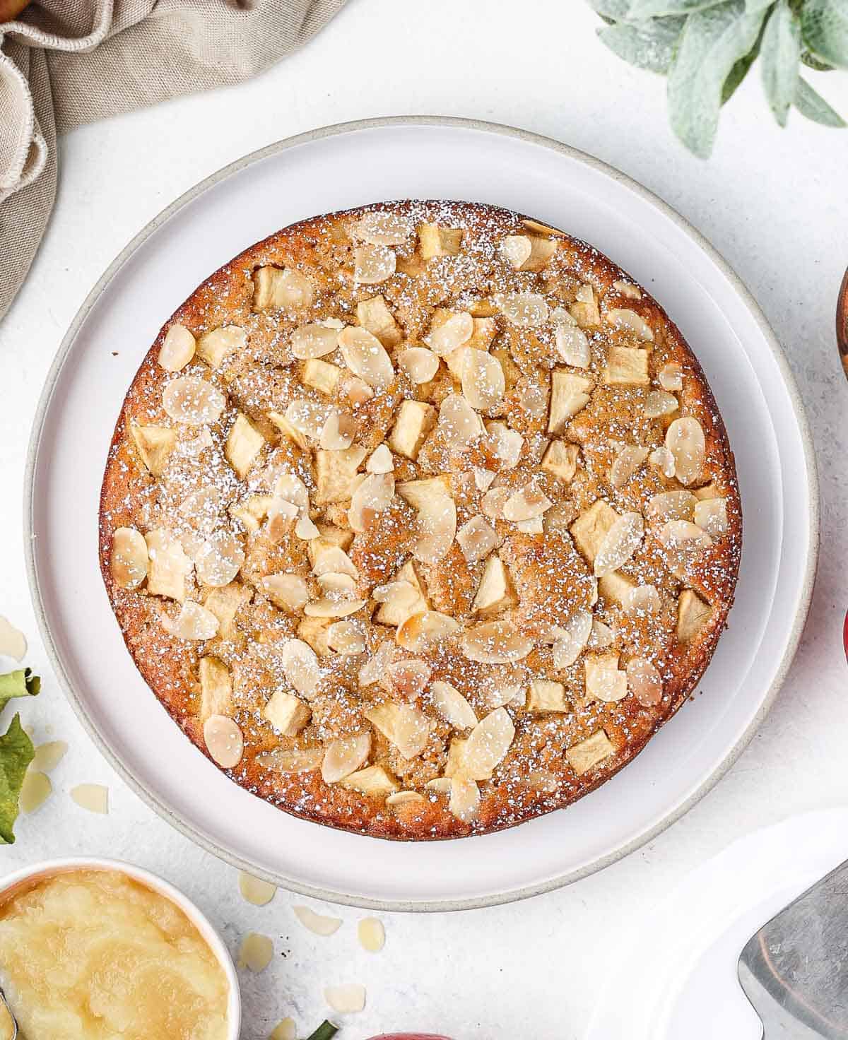 Apple cake seen from above on a large white plate.