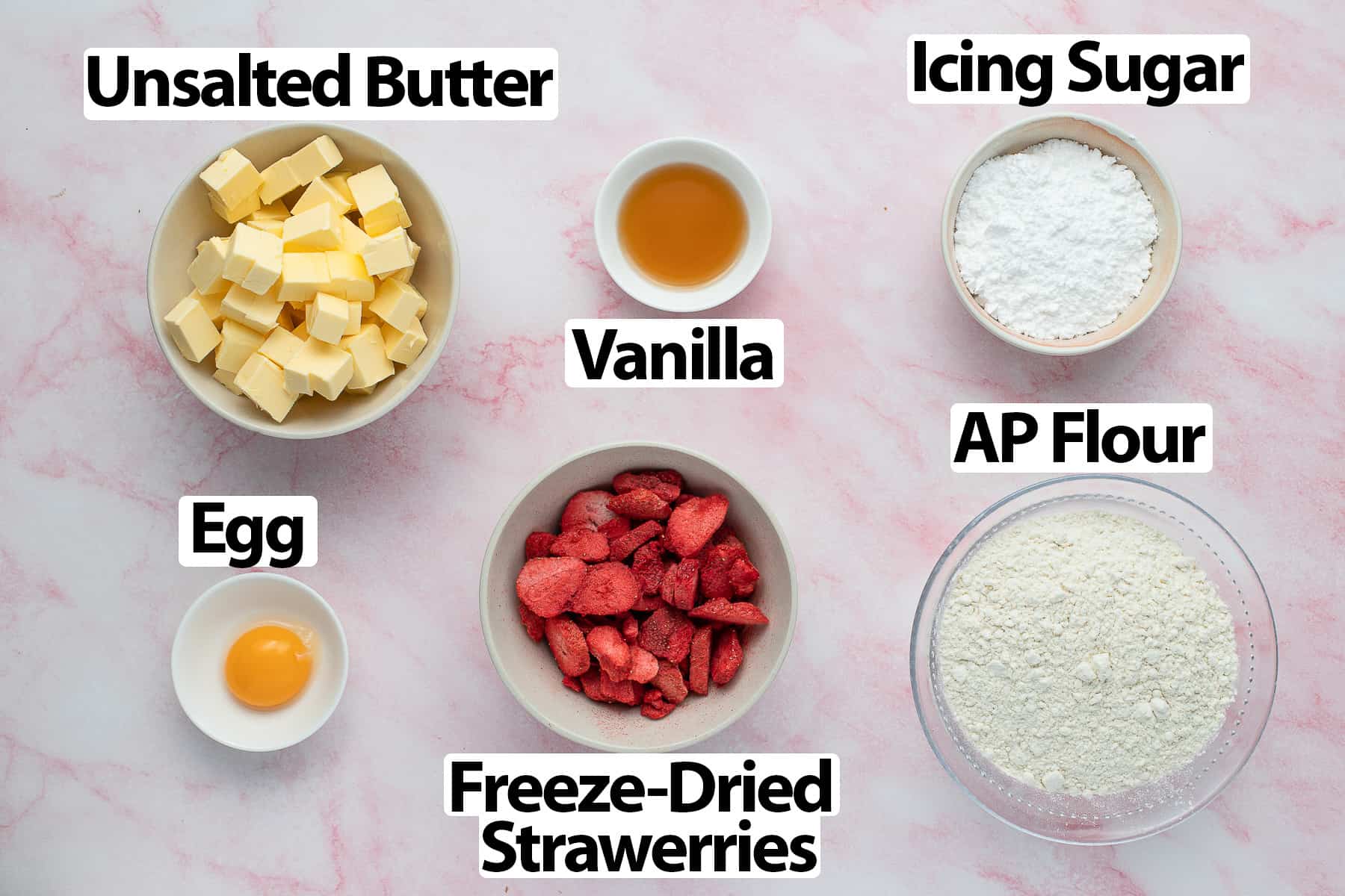 Ingredients on a pink marble surface.
