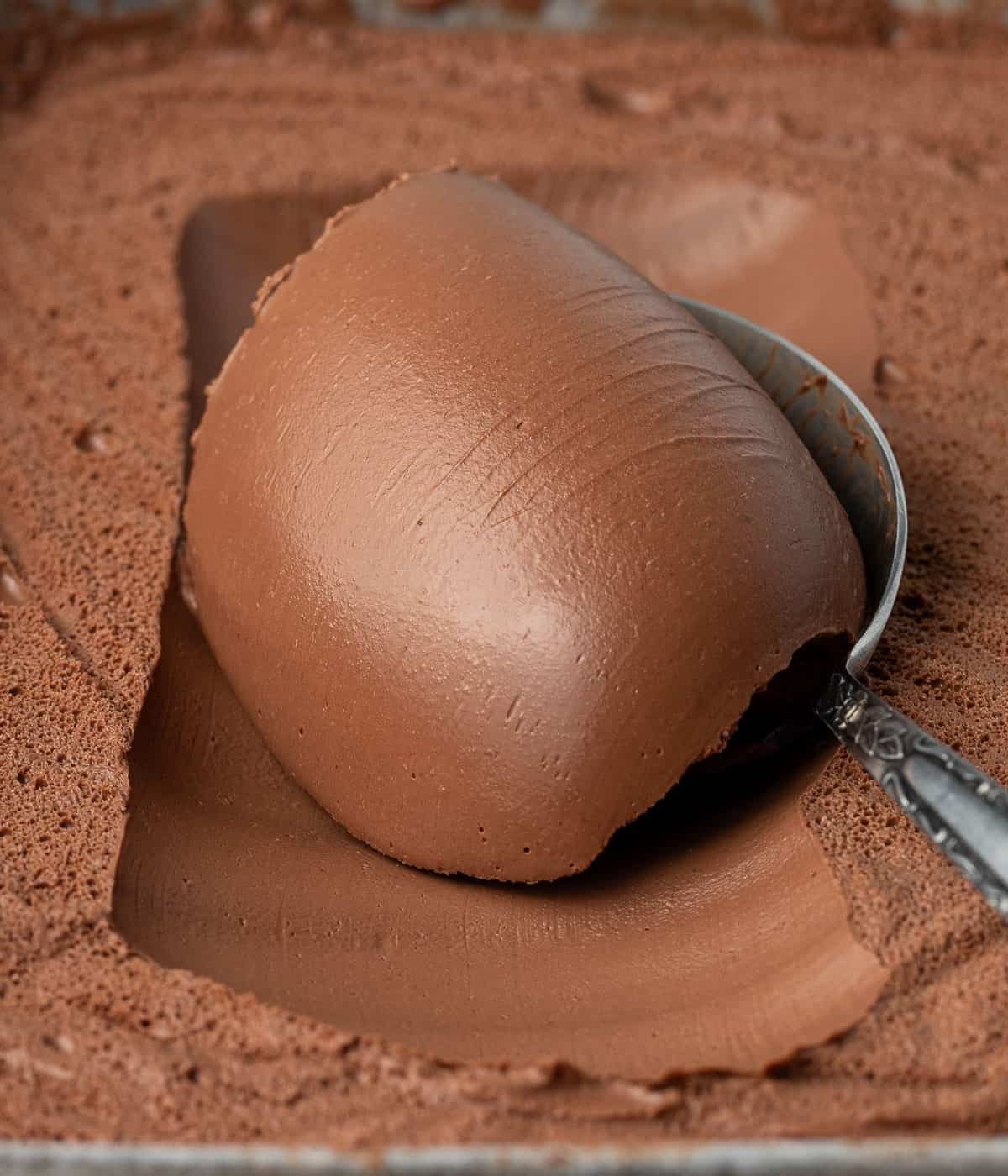 Close up on some cream scooped over a spoon.