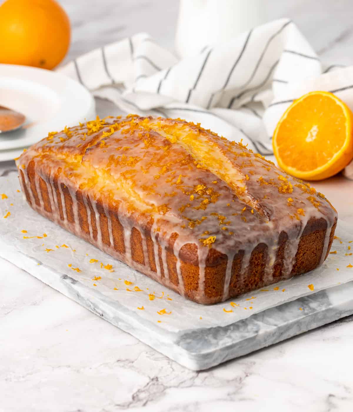 Iced loaf over a grey marble platter.