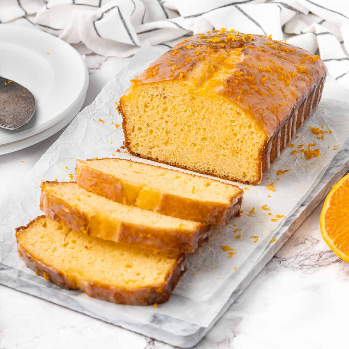 Loaf on a marble tray with three slices cut off.