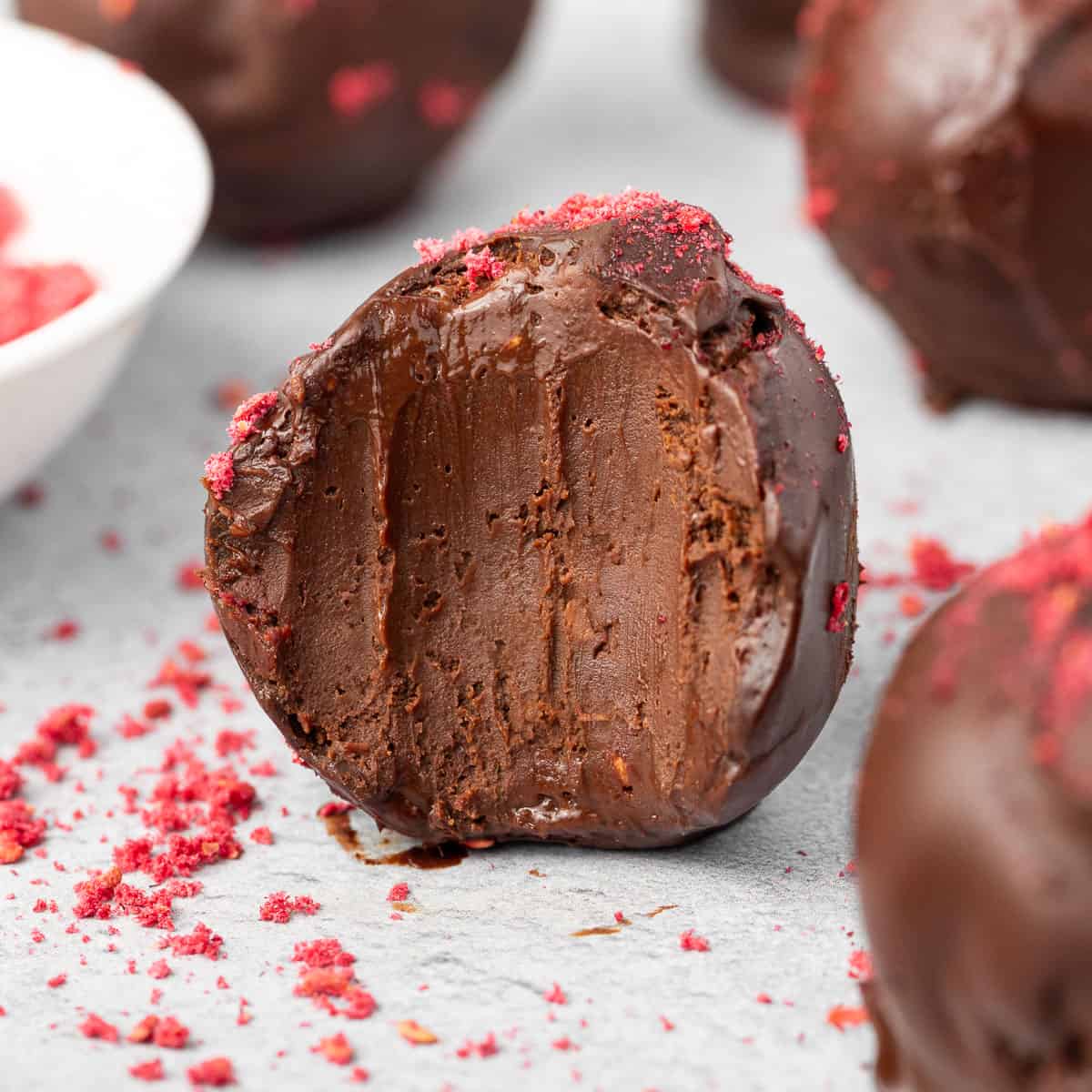 Close up on a truffle with a bite taken off.