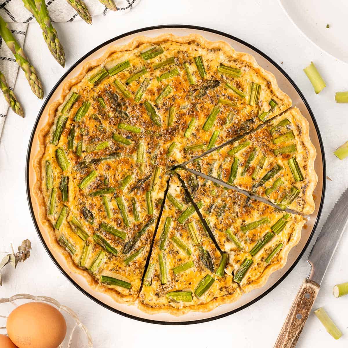 Quiche seen from above with 3 slices cut out.