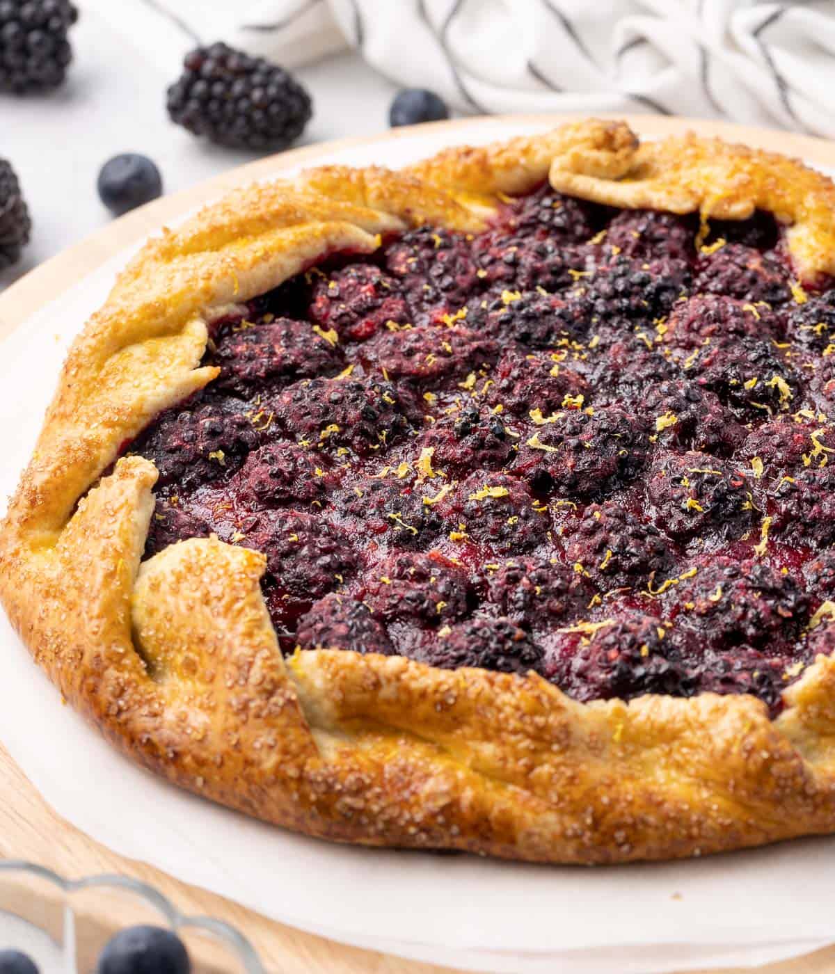 Side view on the galette placed over a round wooden board.