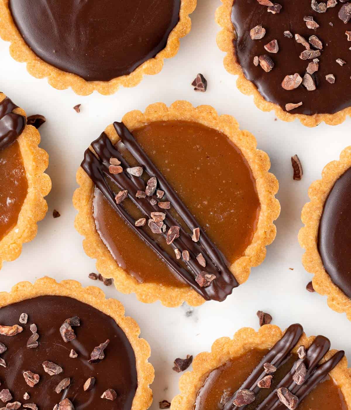 Tartlets seen from above on a white surface.