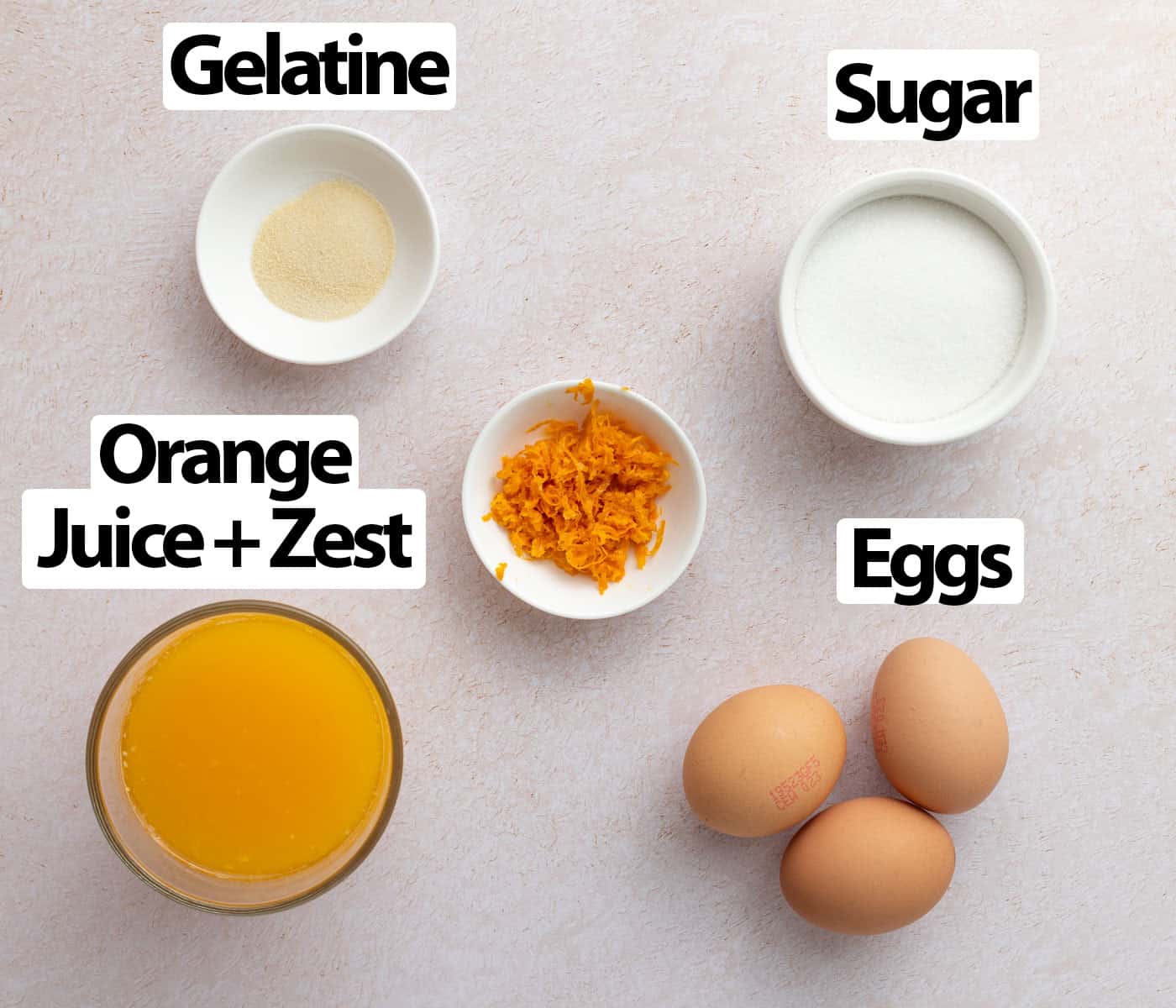 Ingredients laid on a light orange surface seen from above.