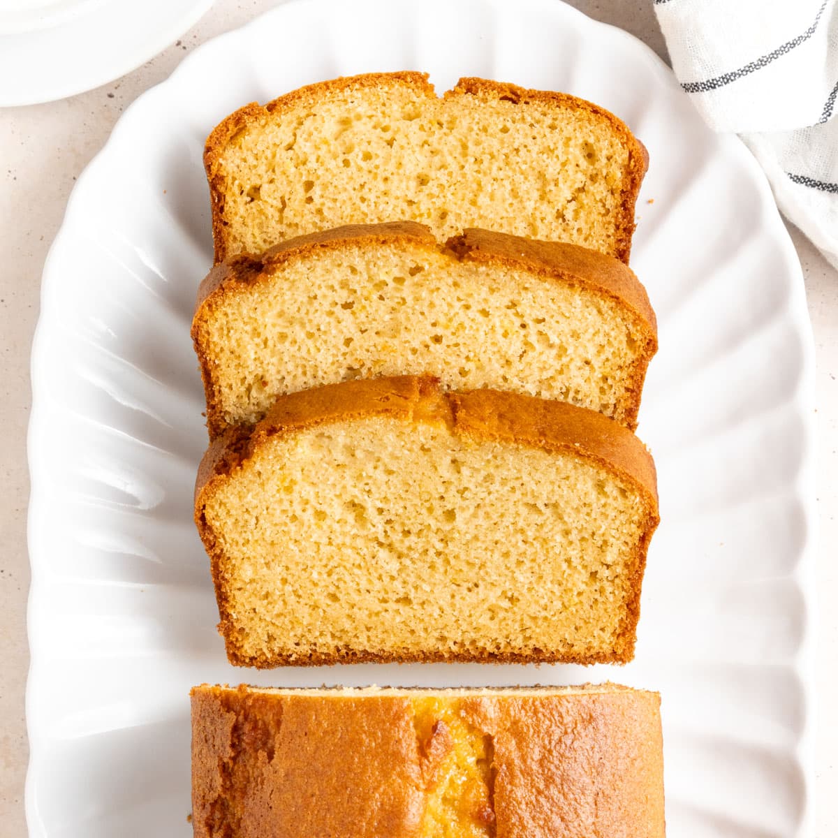 Stack of 3 slices of cake seen from above on an oval white plate.