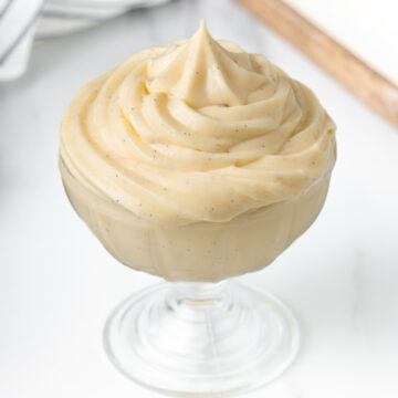 Close up on the cream piped inside a glass cup.