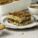 Close up on a slice of speculoos tiramisu on a small white plate.