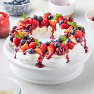 Pavlova Wreath over a white cake stand.