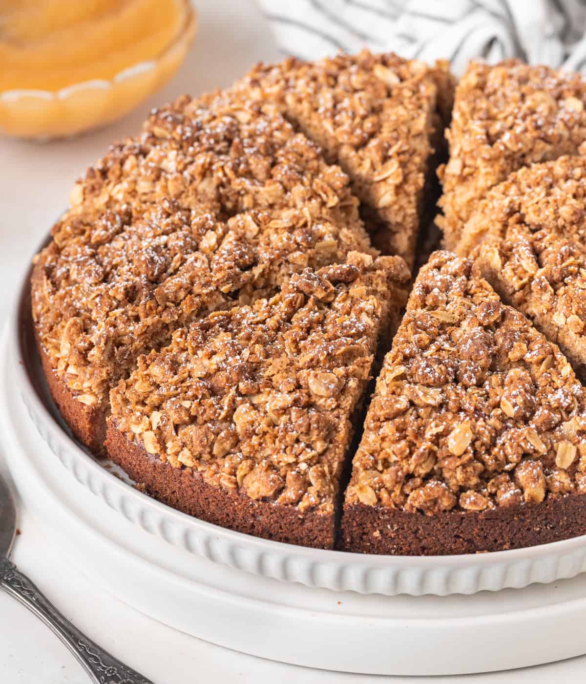 Cake sliced into 8 pieces on a large white plate.