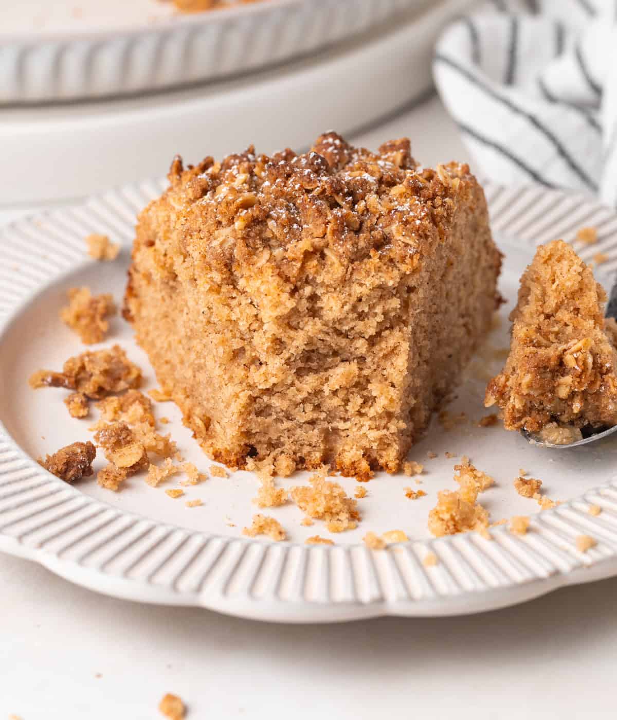 Close up on a cake slice with a bite taken off.