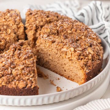 Applesauce cake cut into slices on a large white plate.