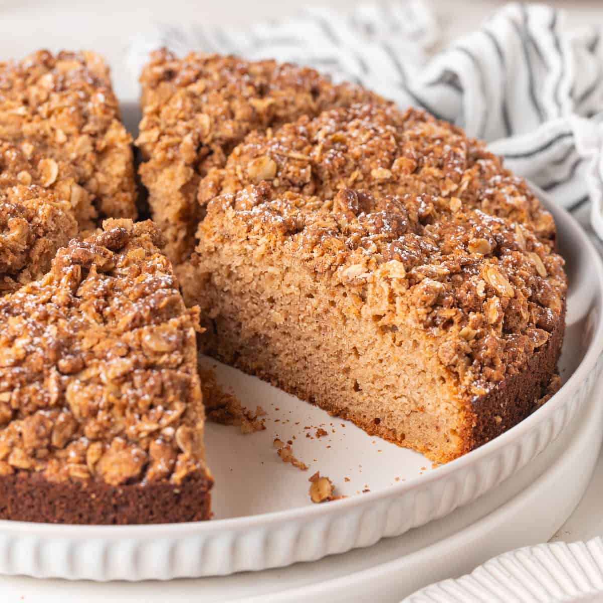 Applesauce cake cut into slices on a large white plate.